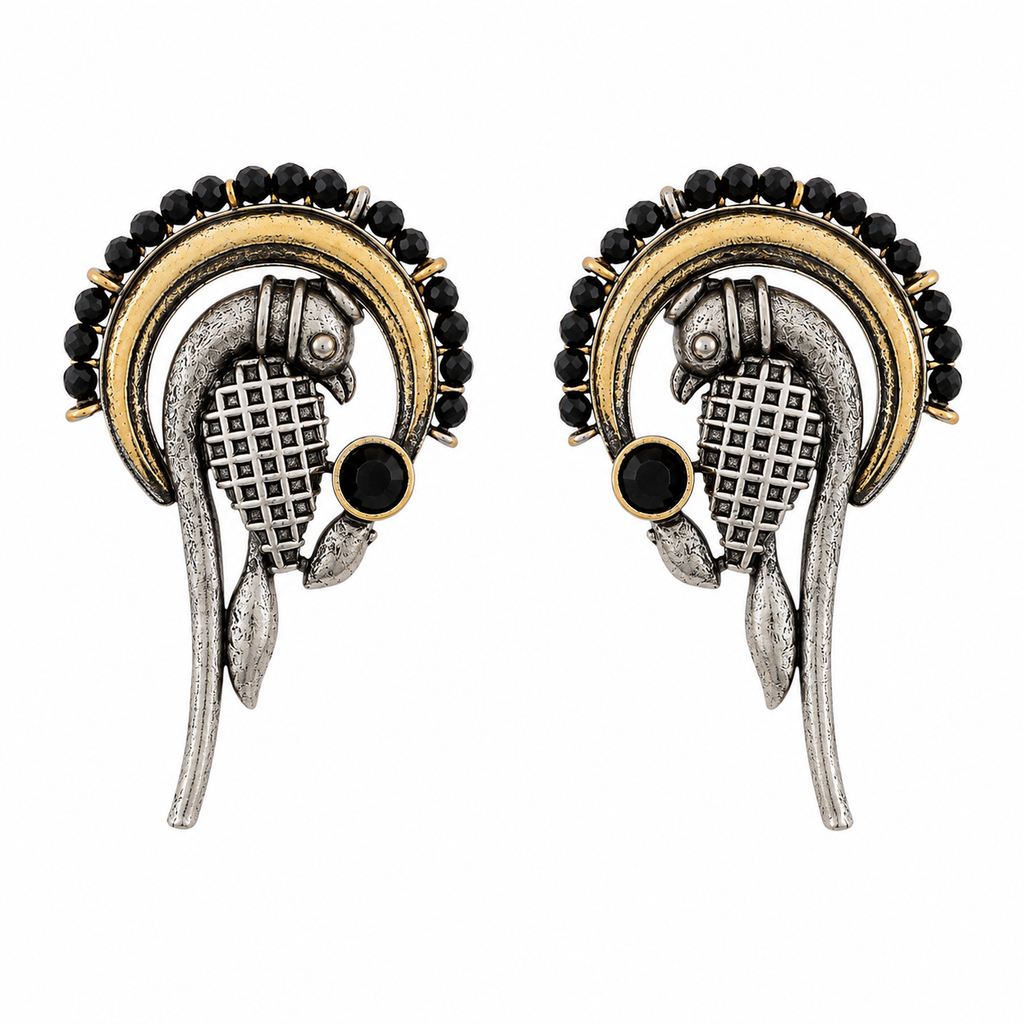 A pair of traditional Indian earrings featuring a silver-toned and gold-toned metal design with black bead borders and a central black stone, set against a plain white background.