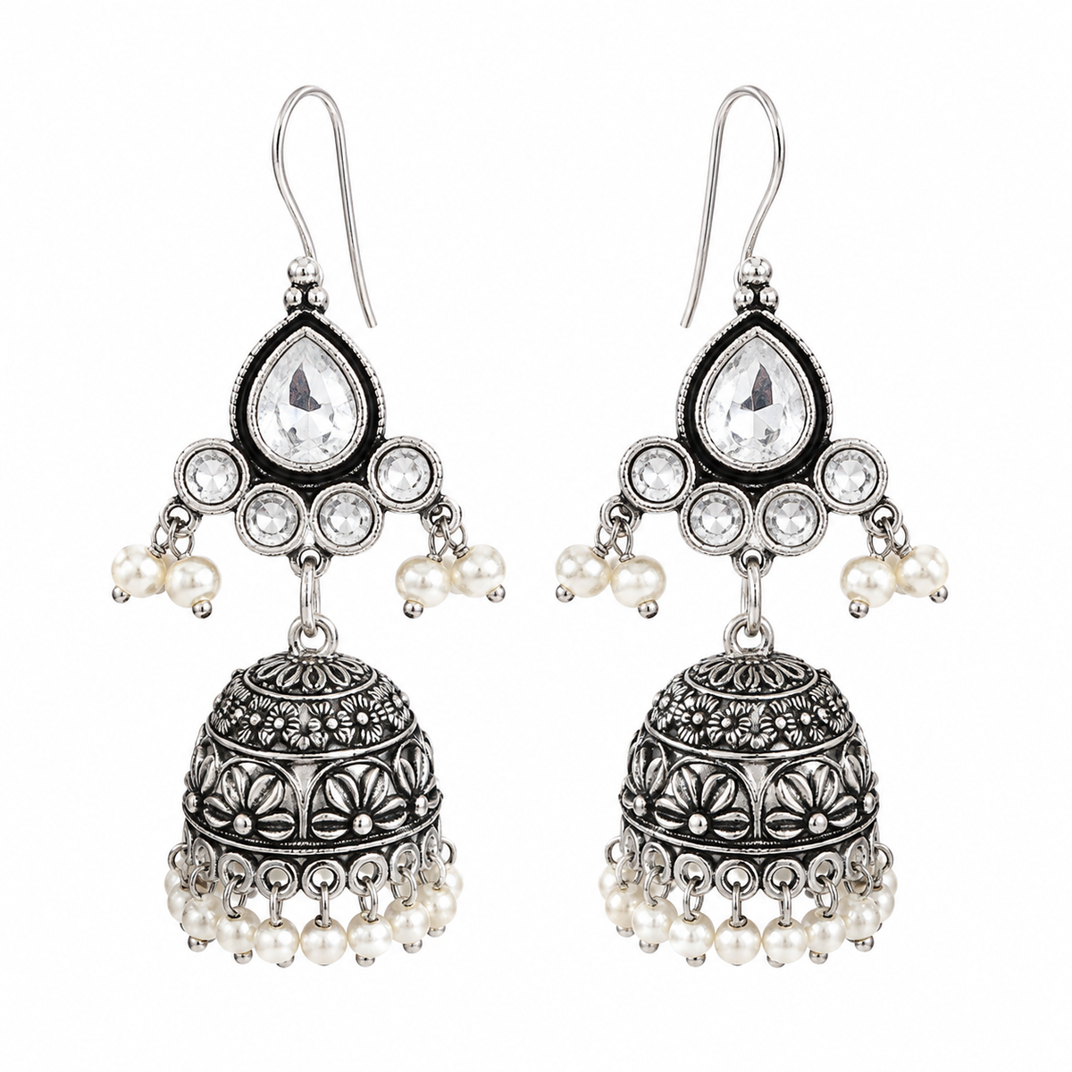 A pair of silver-toned jhumka earrings with clear teardrop stones, small white pearl beads, and intricate filigree detailing, shown on a plain white background.