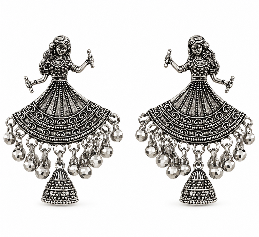 A pair of silver-toned traditional Indian jhumka earrings featuring an intricate dancer design with dangling bell charms, shown against a plain white background.
