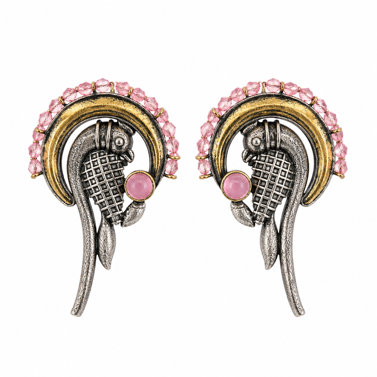 A pair of vintage-style gold and silver earrings featuring pink gemstone accents, set against a plain white background.