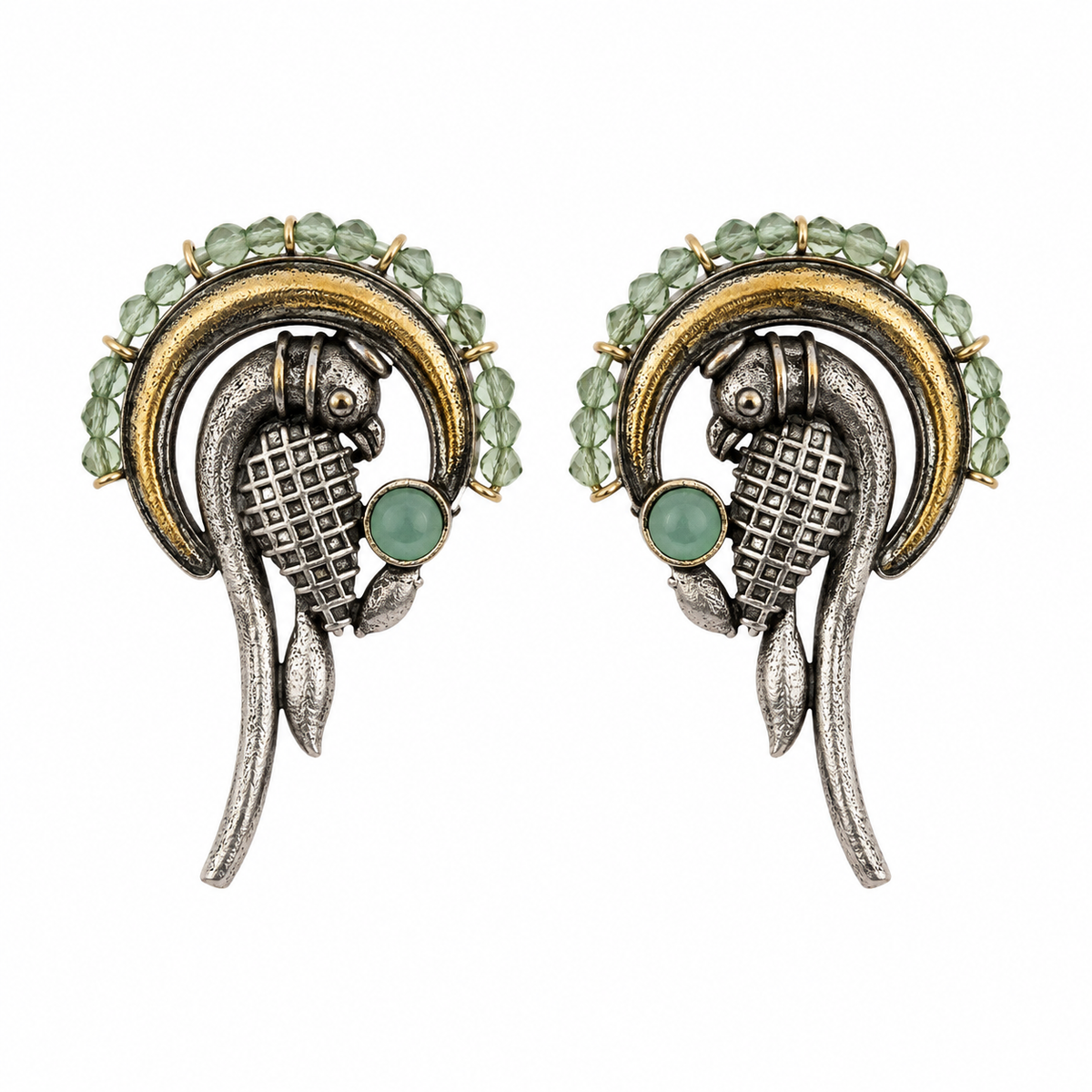 A pair of vintage-style fish earrings featuring textured silver-toned metal, gold-toned accents, and light green faceted gemstones, set against a plain white background.
