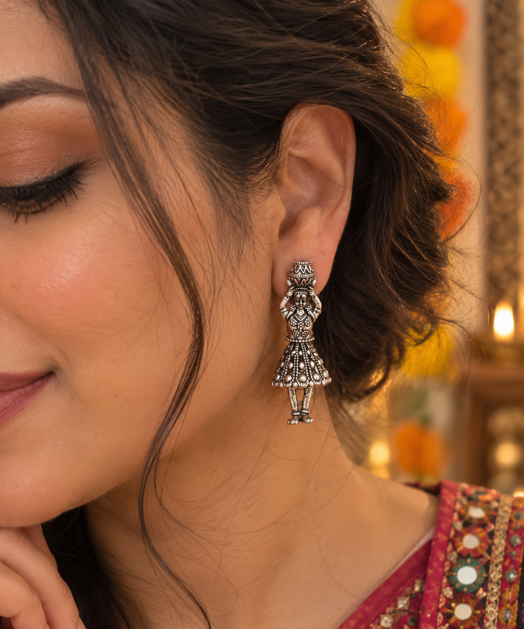 Close up of woman wearing matki designed jhumkis