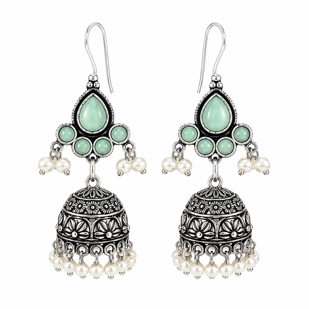 A pair of silver-toned Indian jhumka earrings with mint green stones and white pearl accents, shown on a plain white background.