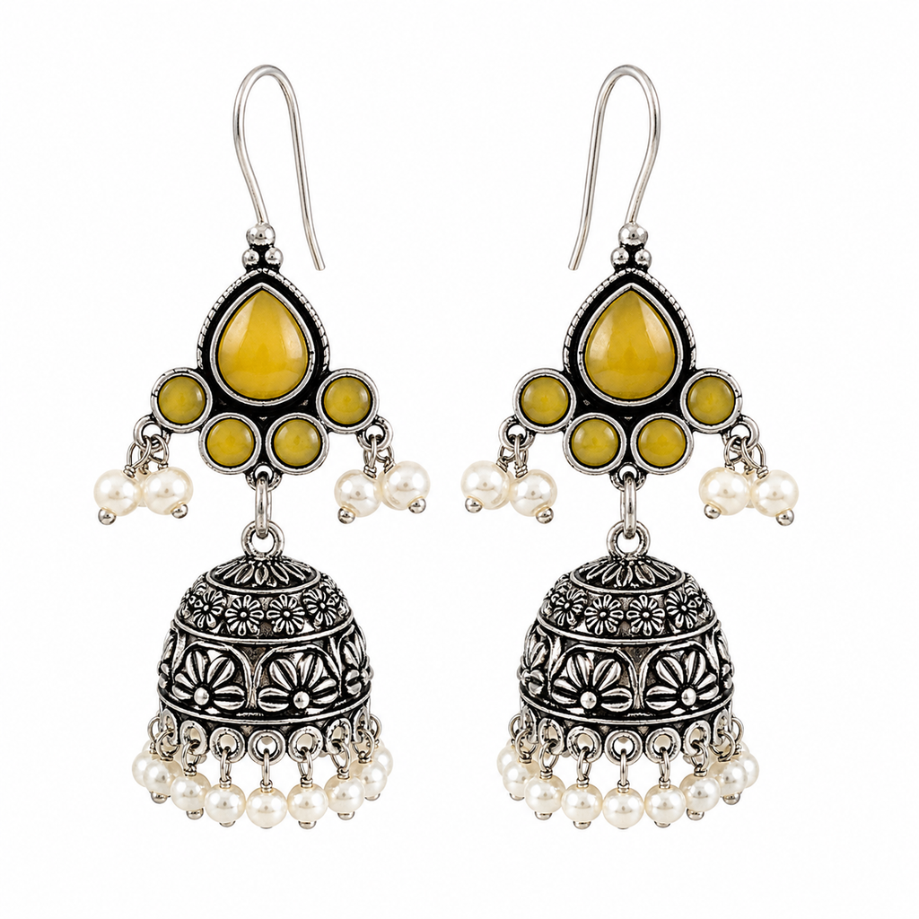 A pair of traditional Indian silver-toned jhumka earrings with yellow stone accents and white pearl bead drops, shown on a plain white background.