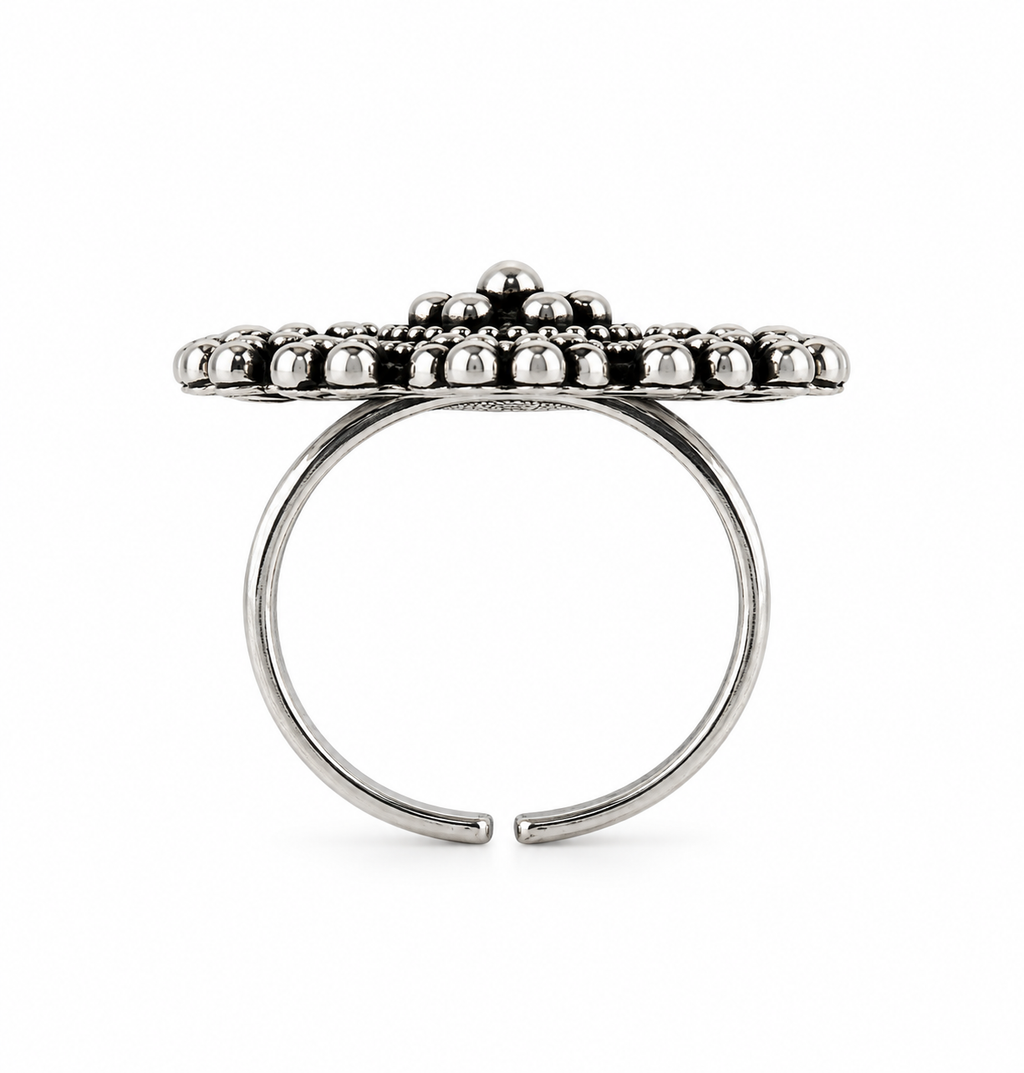 A silver-toned open ring with a wide, beaded top band, photographed against a plain white background.